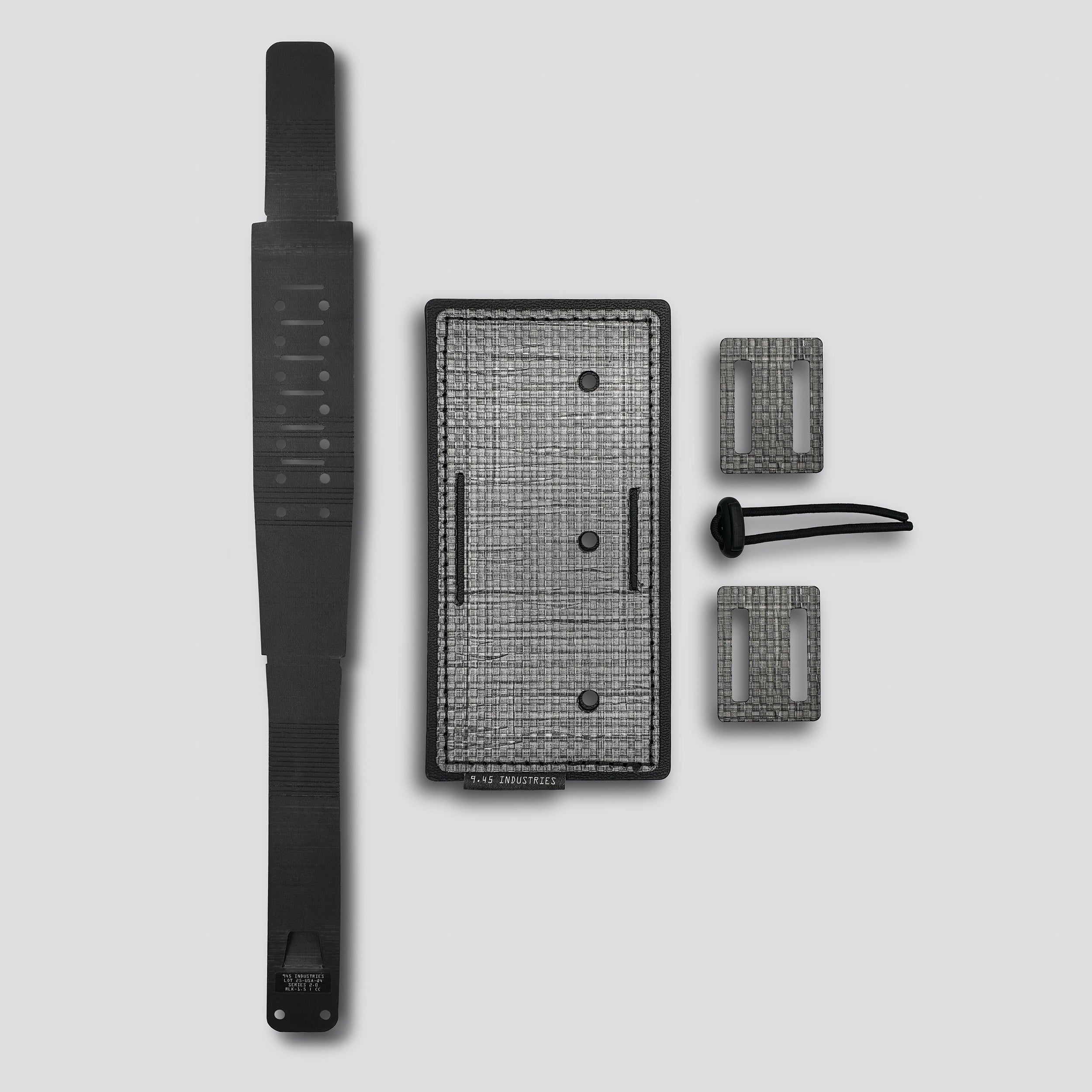 Titanium panel with two loops and belt lock and black locking belt on a light gray background