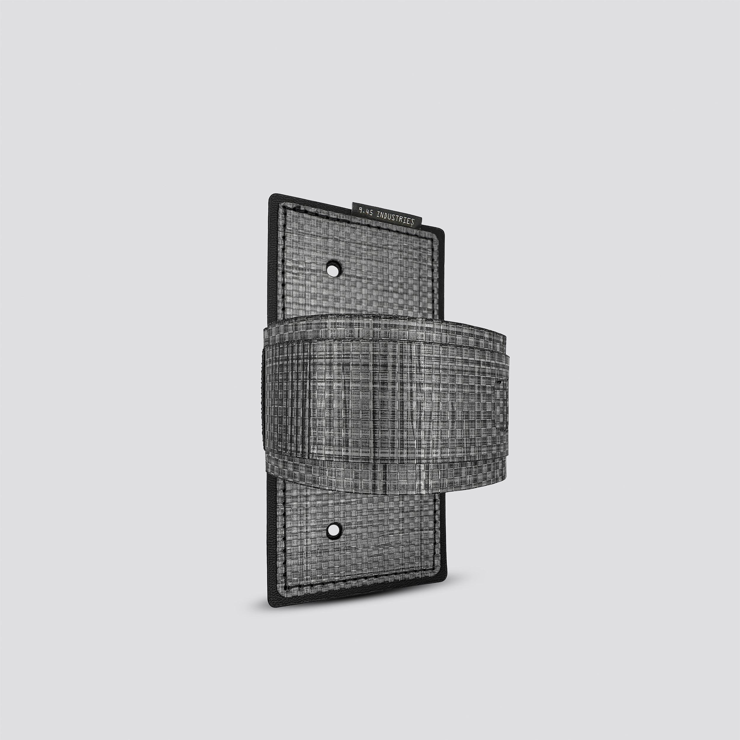 Titanium IWB tegris holster adapter with titanium panel and titanium belt on a light gray background