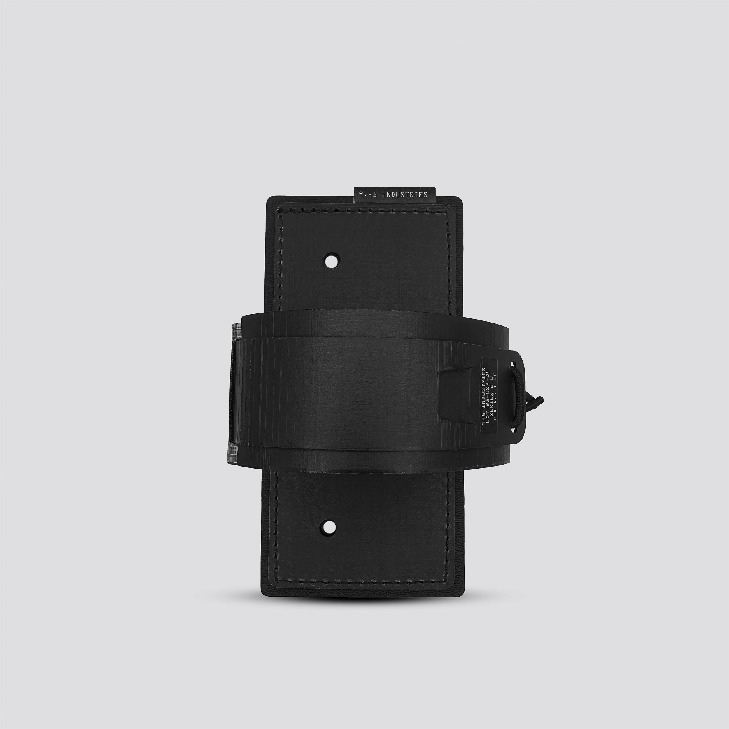 Black IWB tegris holster adapter with black panel and black belt on a light gray background