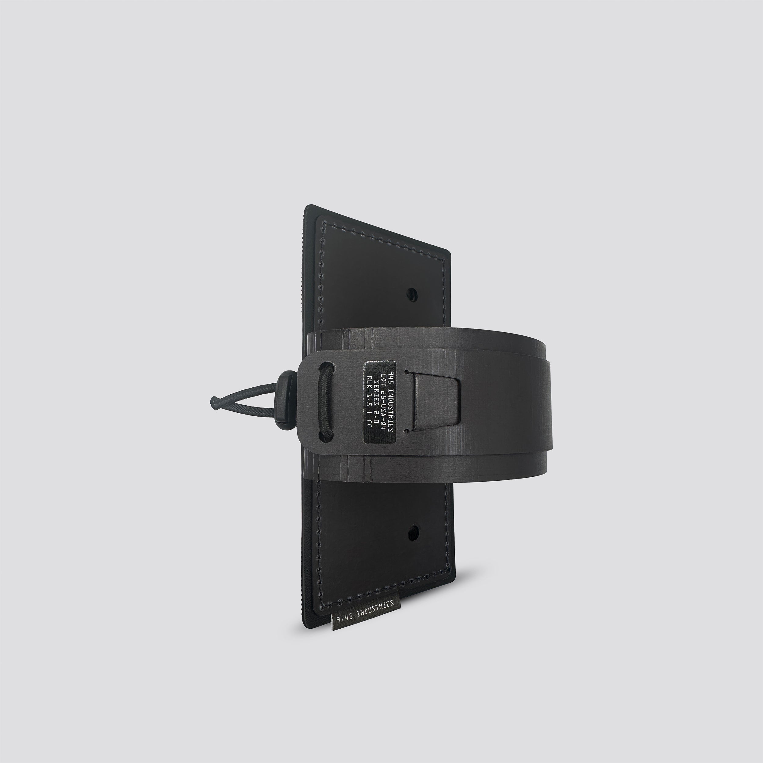 Black IWB Tegris holster adapter with black panel and belt on a light gray background