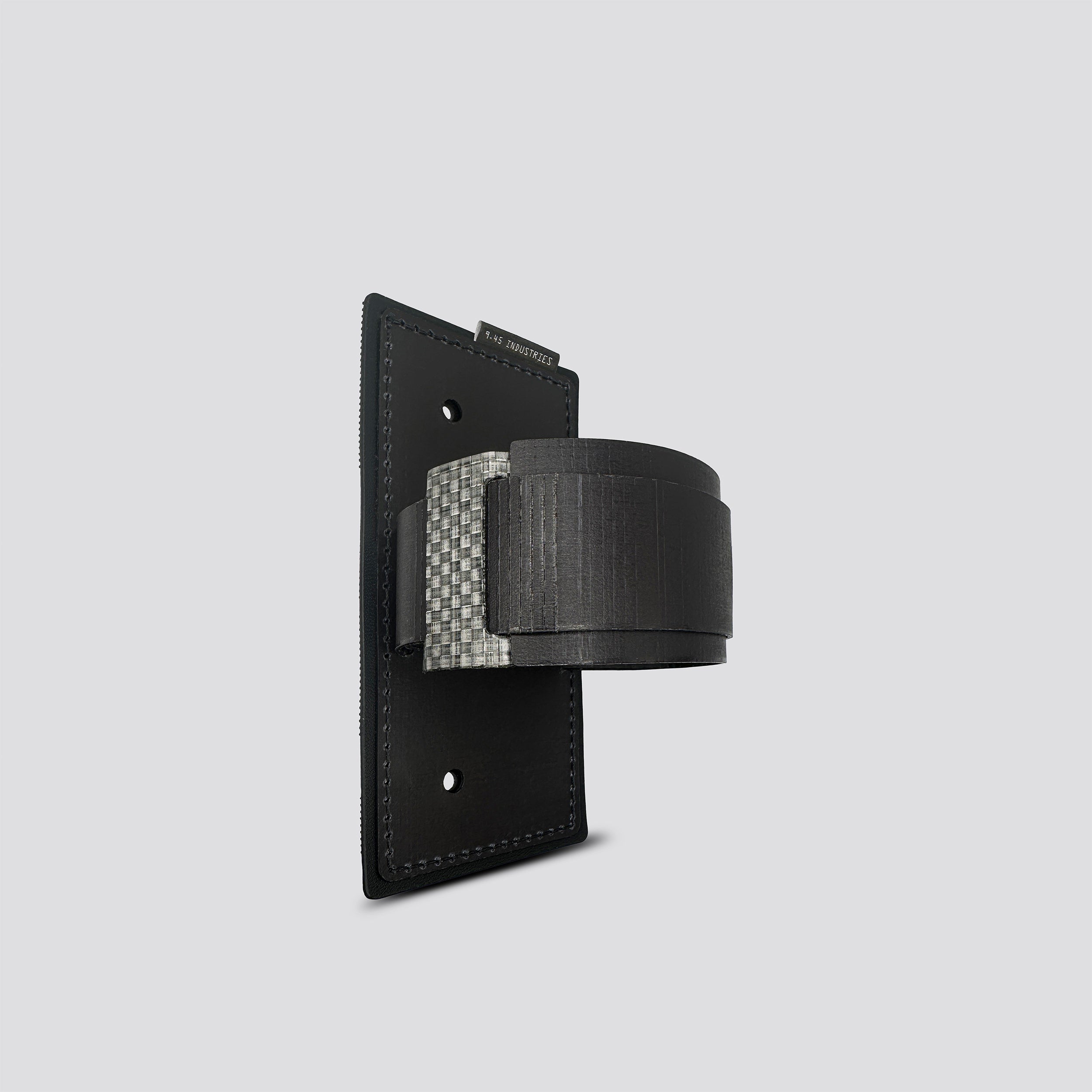 Black IWB Tegris holster adapter with black panel and belt on a light gray background