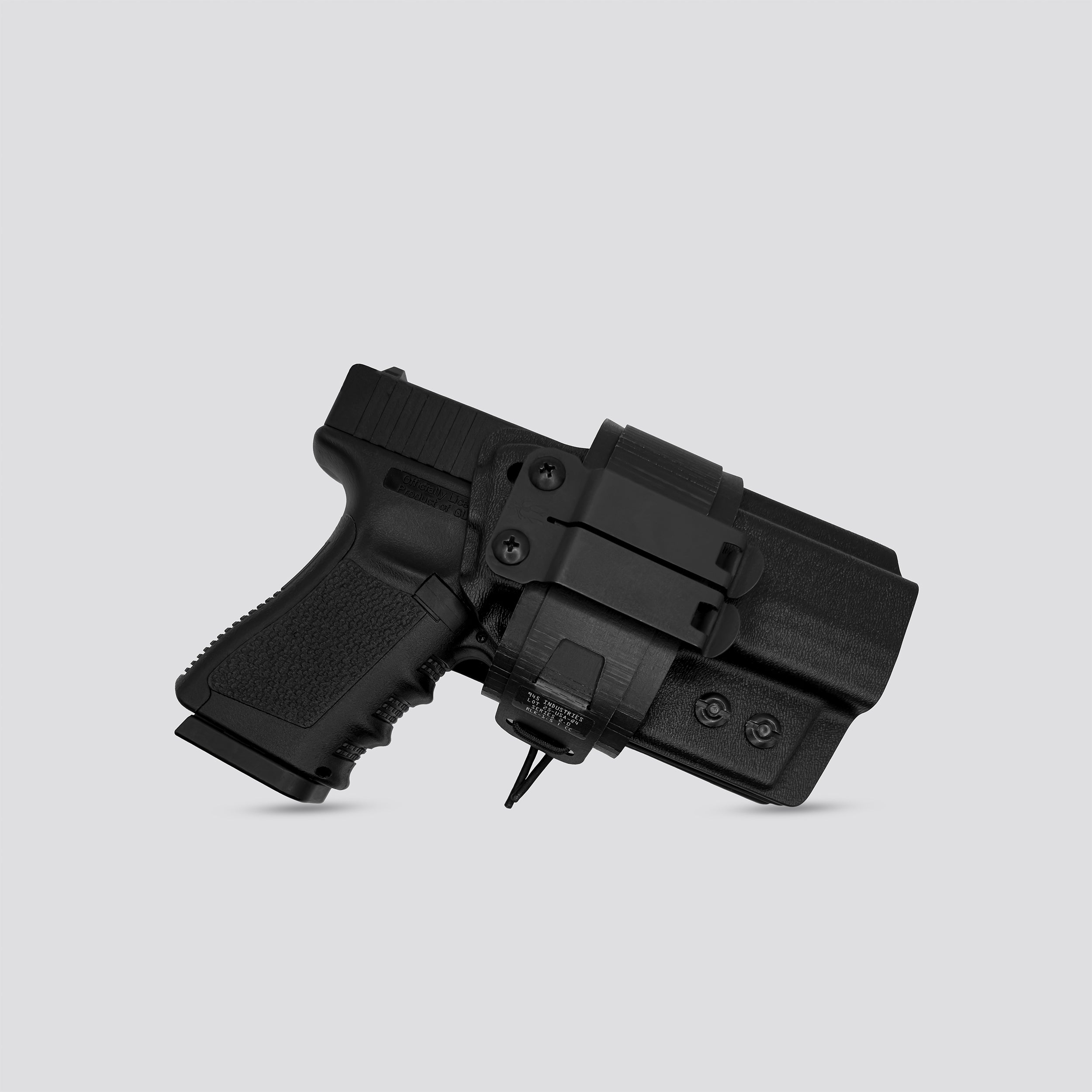 Black IWB Tegris holster adapter with black panel and belt with IWB holster on a light gray background
