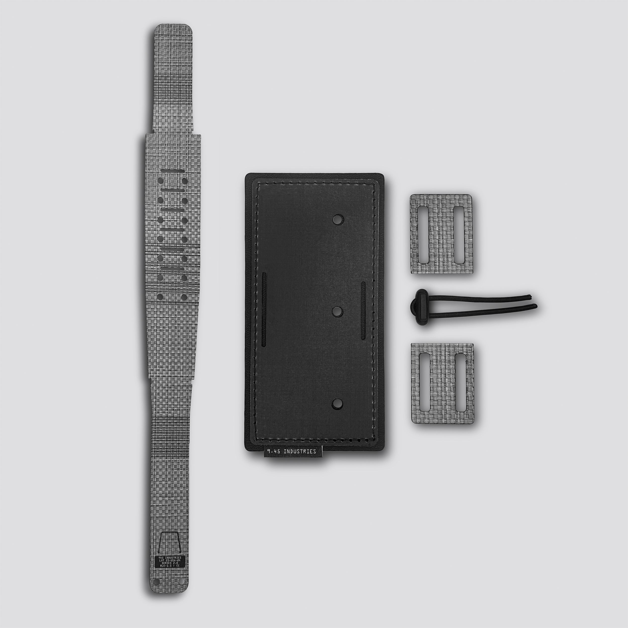 Black panel with two loops and belt lock and titanium locking belt on a light gray background