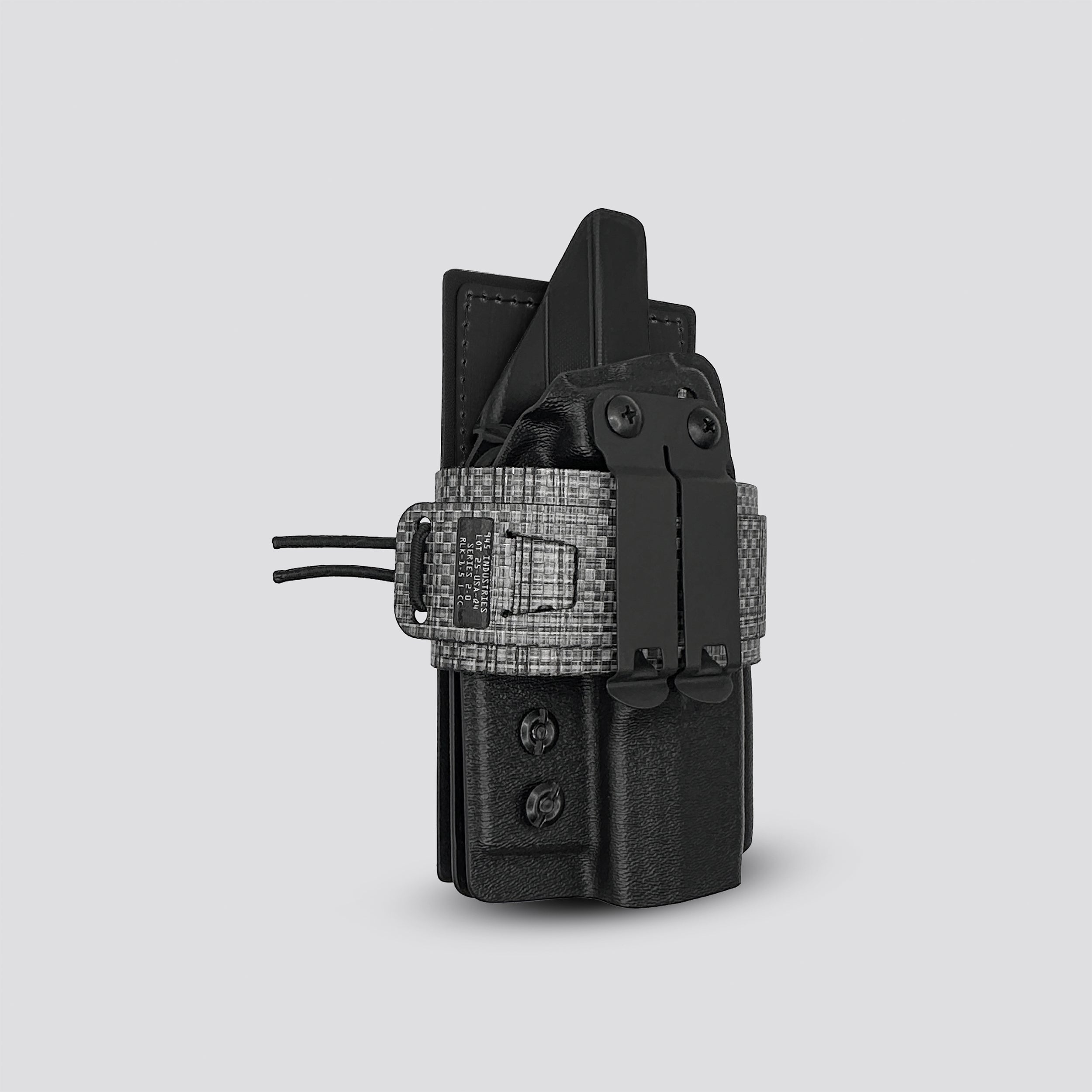 Tiitanium on black IWB tegris holster adapter with black panel and titanium belt with IWB holster on a light gray background